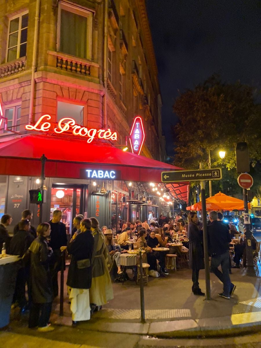 People socializing outside a restaurant in Europe